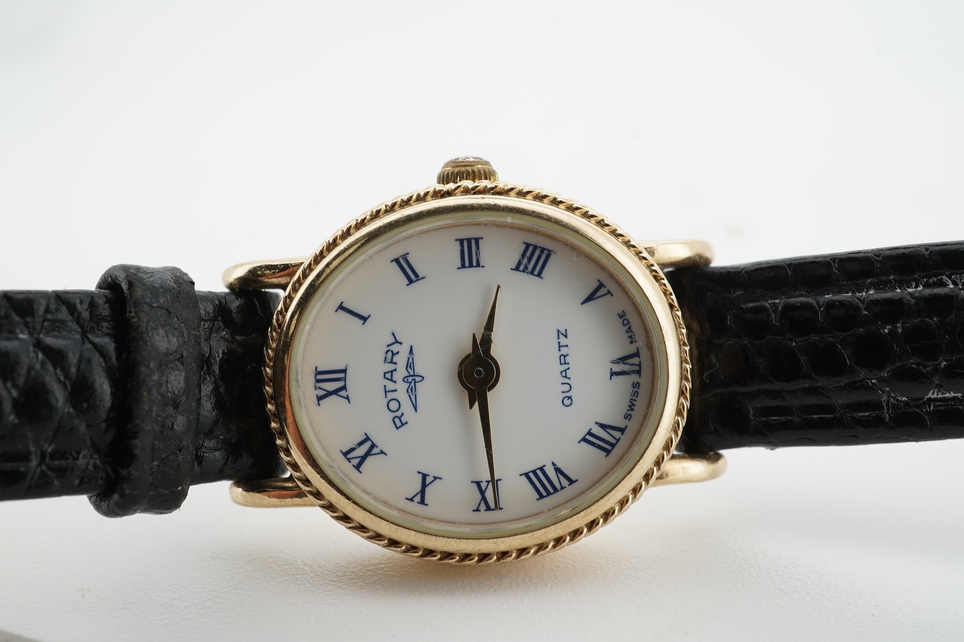 A lady's recent 9ct gold Rotary quartz wrist watch, with oval Roman dial, case diameter 18mm, on an associated leather strap, no box or papers.